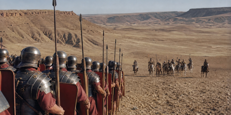 Legionários romanos em formação observam arqueiros montados partas à distância na paisagem árida de Carras